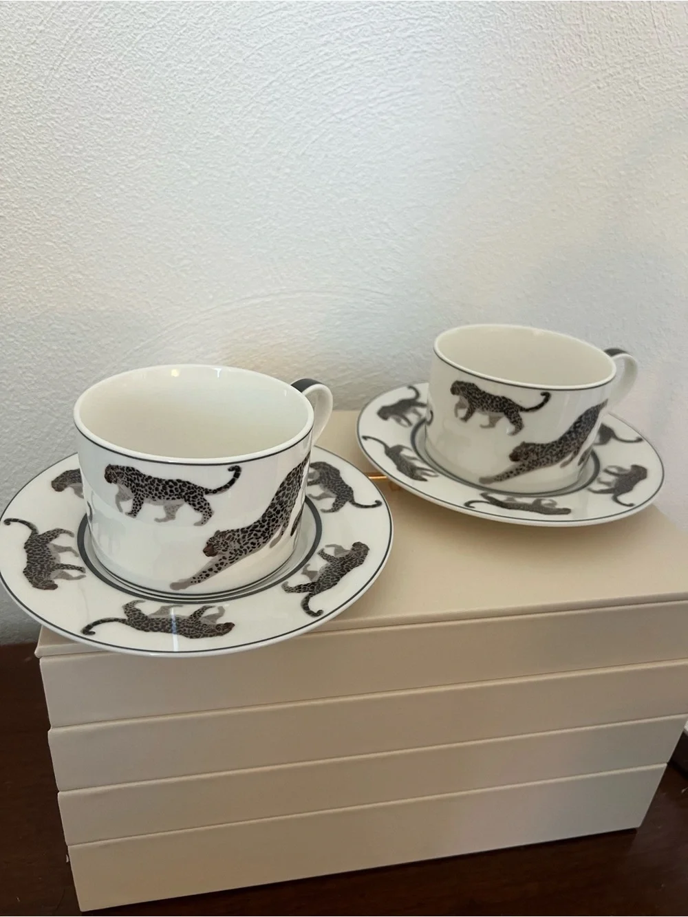 Cup and saucer set with black leopard print on white background